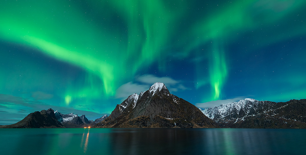 Sudan løn mel Northern Lights – Aurora Borealis shine in sky over Olstind mountain peak  and fjord near Reine, Moskenesøy, Lofoten Islands, Norway | Academy Travel  USA